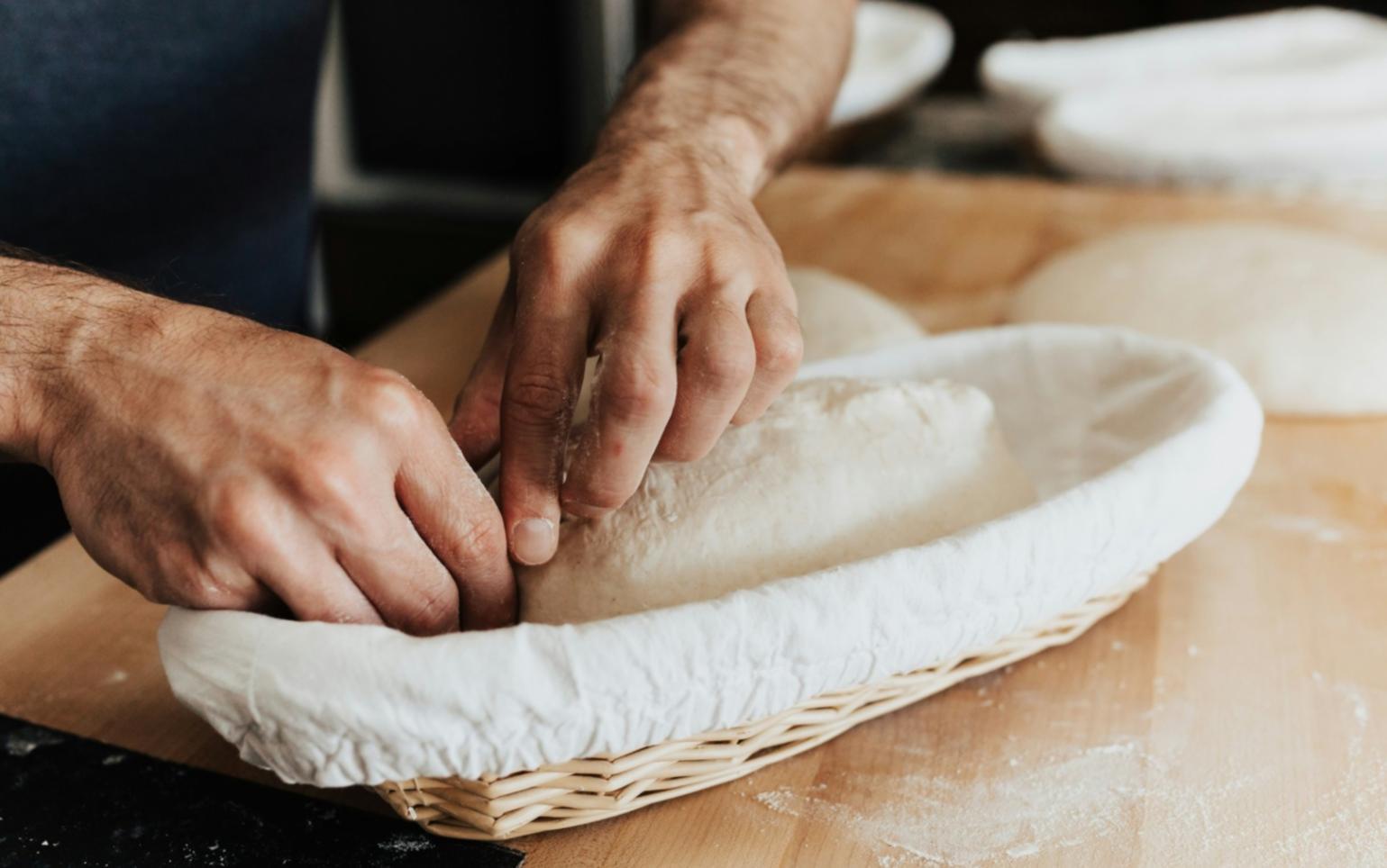Professional Italian kitchen training facility showing wood-fired oven, preparation stations, and authentic cooking equipment