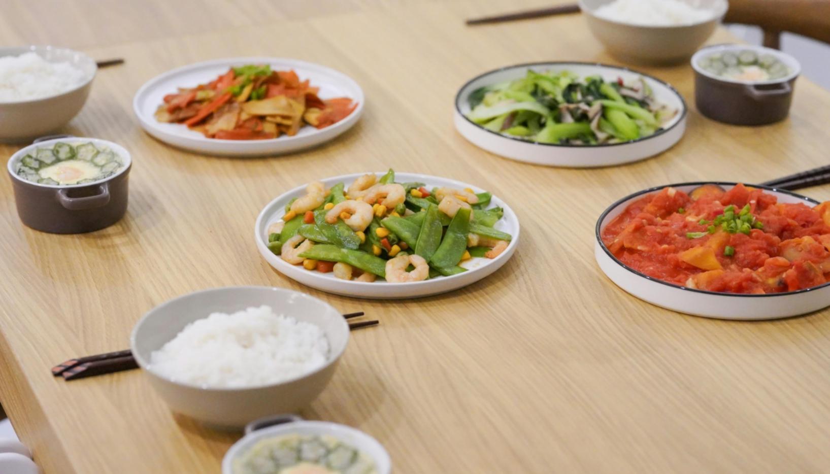 Professional pizza chef instructing students on proper wood-fired oven techniques in commercial training facility